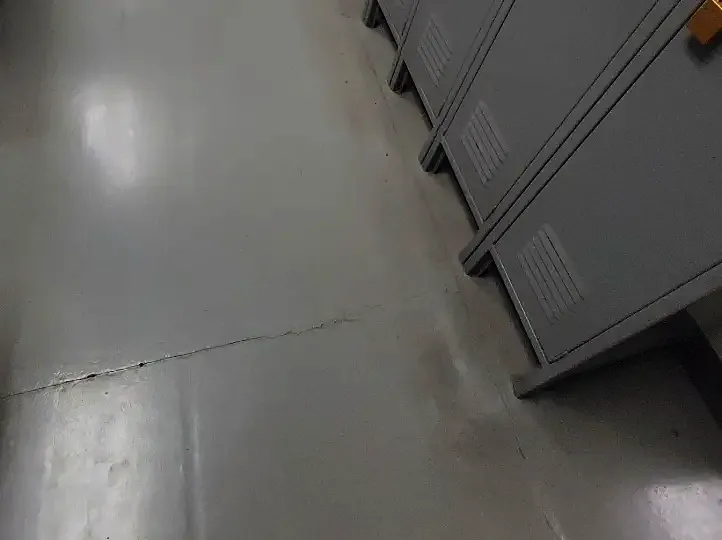 Before: grey floor beside a row of lockers