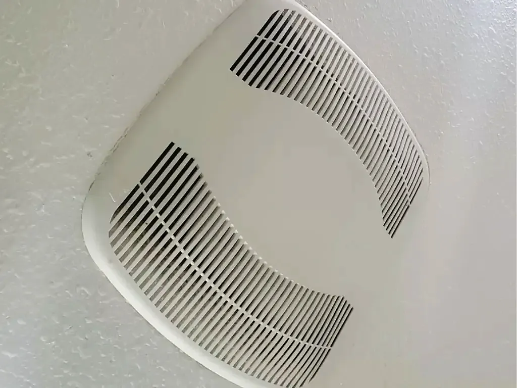 After: bathroom exhaust fan cover on a textured ceiling